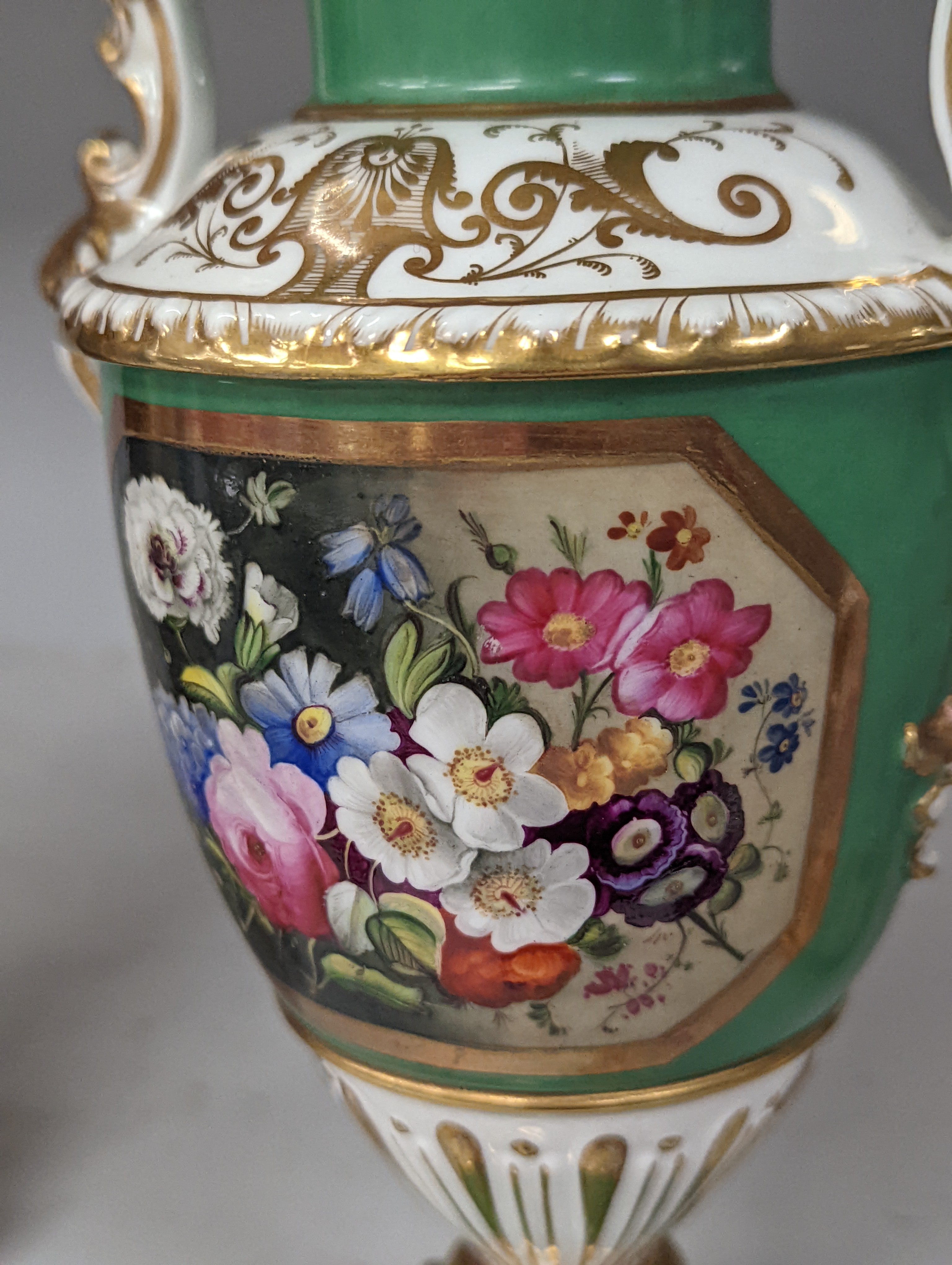 An English porcelain two handled vase painted with flowers in a panel on a green ground, probably Grainger Worcester, c.1830, height 24cm